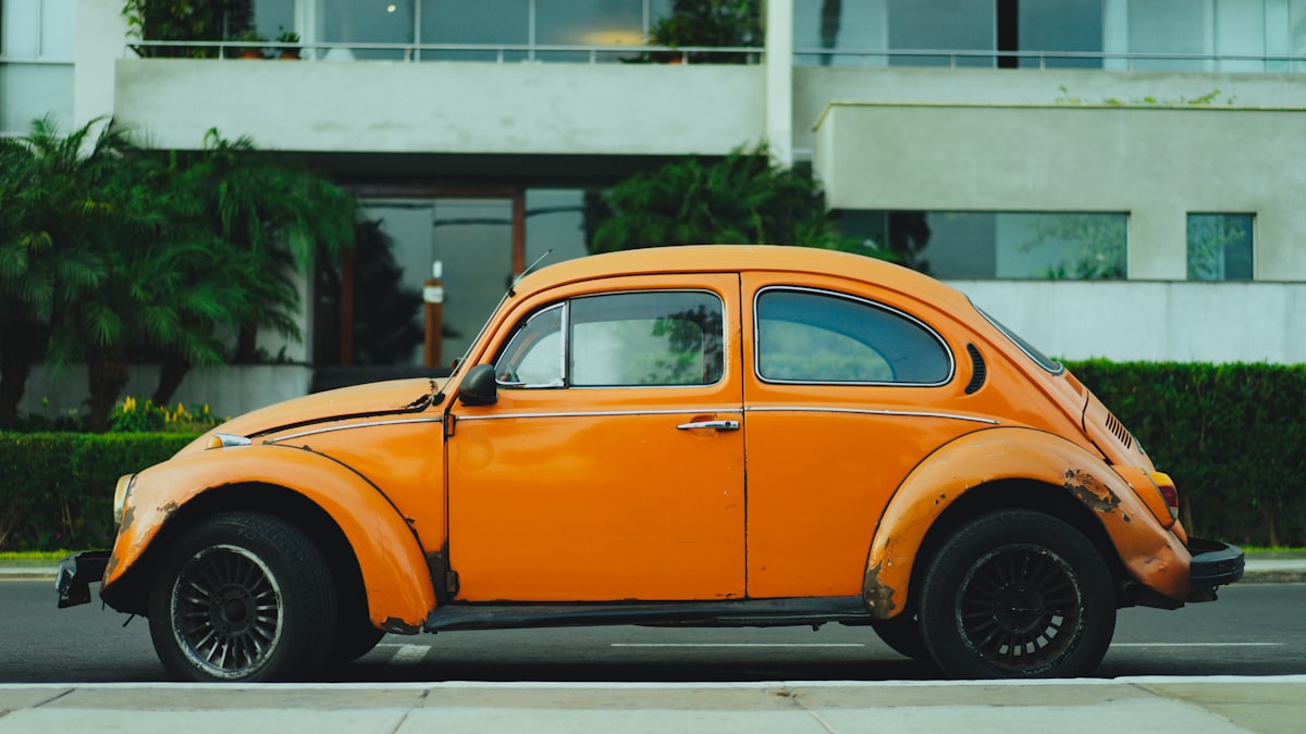 Older orange car showing visible wear, due for a service