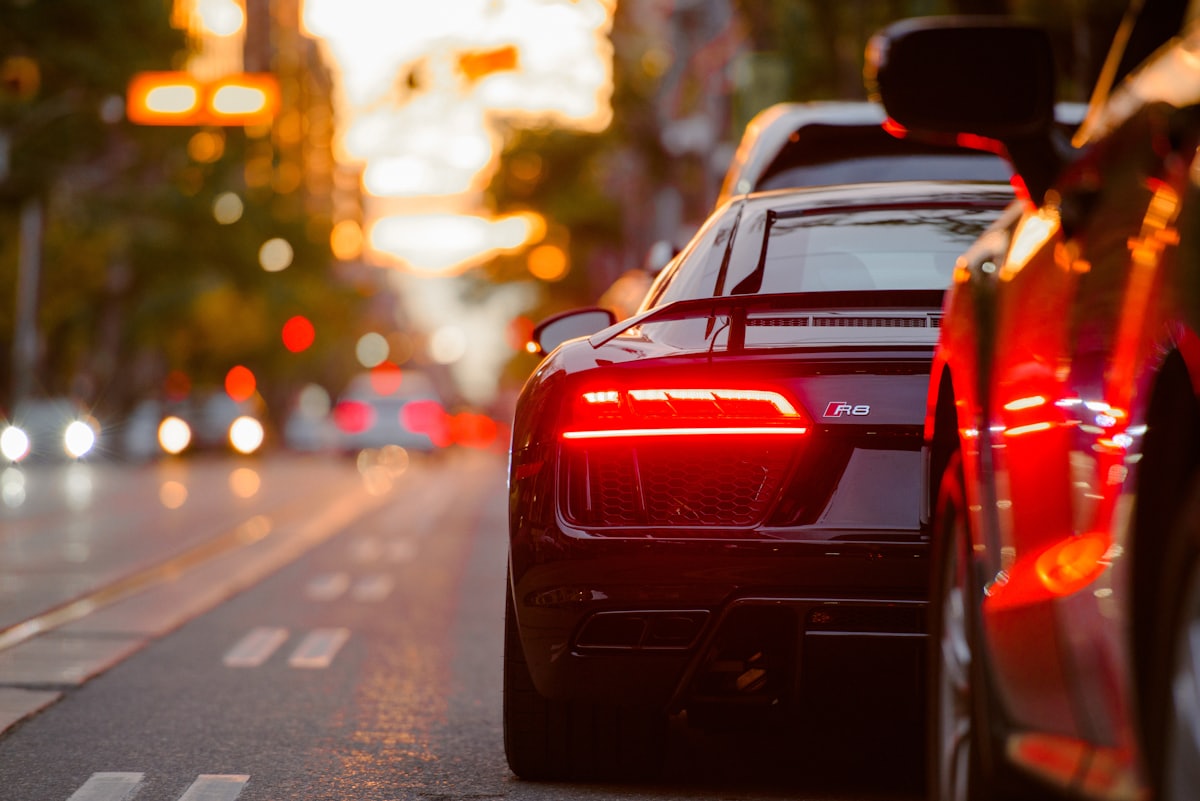 Car brake lights glowing in evening city traffic